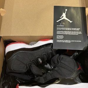 Air Jordan 11 Retro blk/Red/White limited edition.Size 5 in boys fits 6.5 women